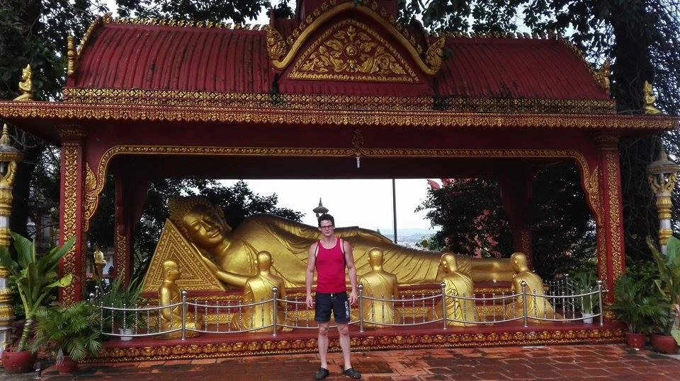 Tourist in front of buddhist statue